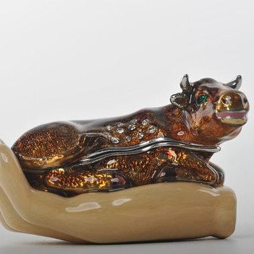 Keren Kopal Zodiac Ox Laying on Hand